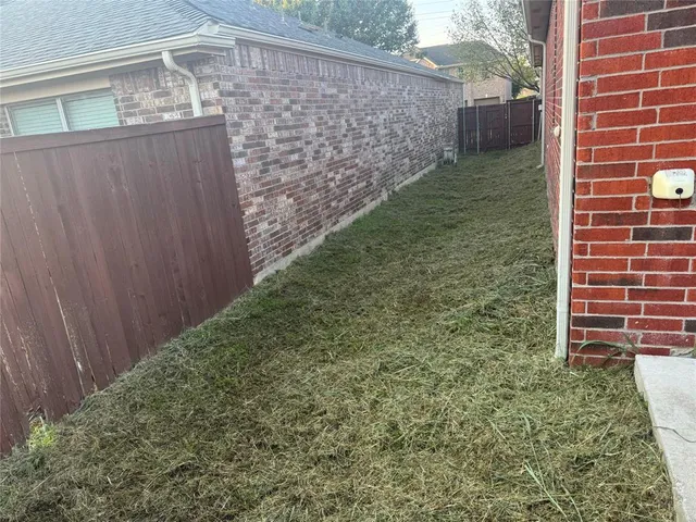 a kitchen with kitchen island granite countertop a sink and a stove top oven with wooden cabinets