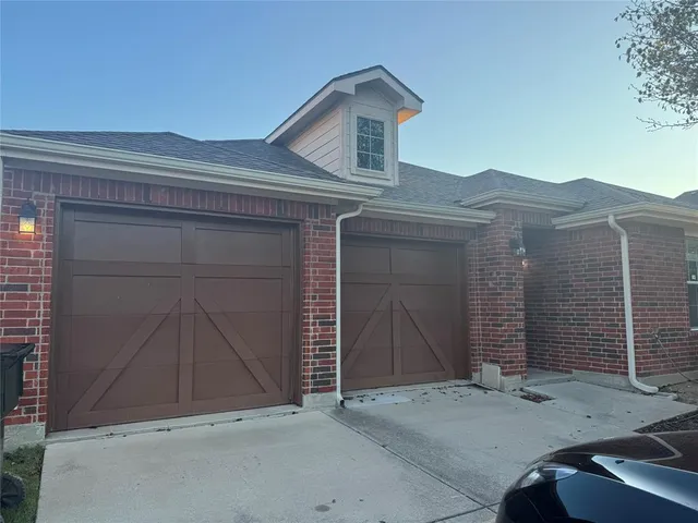 a view of an empty room with wooden floor and a cabinet
