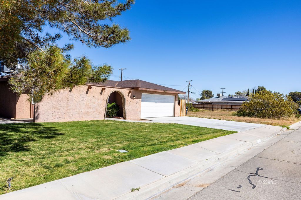 1144 West Benson Avenue Ridgecrest, CA 93555 - Photo 3 of 32 a view of a back yard of the house