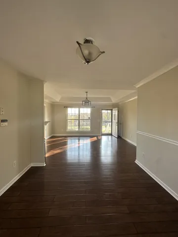 a view of a room with window and wooden floor