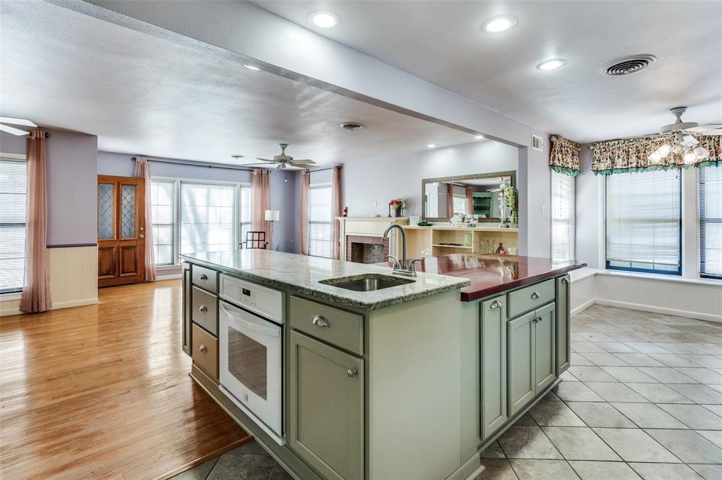 813 19th Street Plano, TX 75074 - Photo 5 of 12 a kitchen with stove cabinets and wooden floor