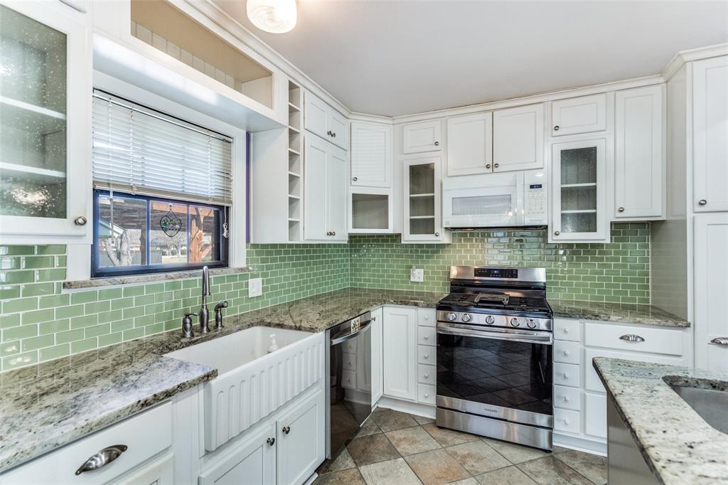 813 19th Street Plano, TX 75074 - Photo 6 of 12 a kitchen with stainless steel appliances granite countertop a stove and a sink