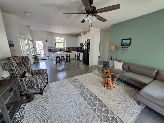 a living room with furniture and a chandelier