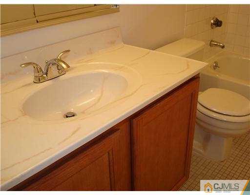 716 B Delair Road Monroe Township, NJ 08831 - Photo 12 of 13 a bathroom with a sink and toilet