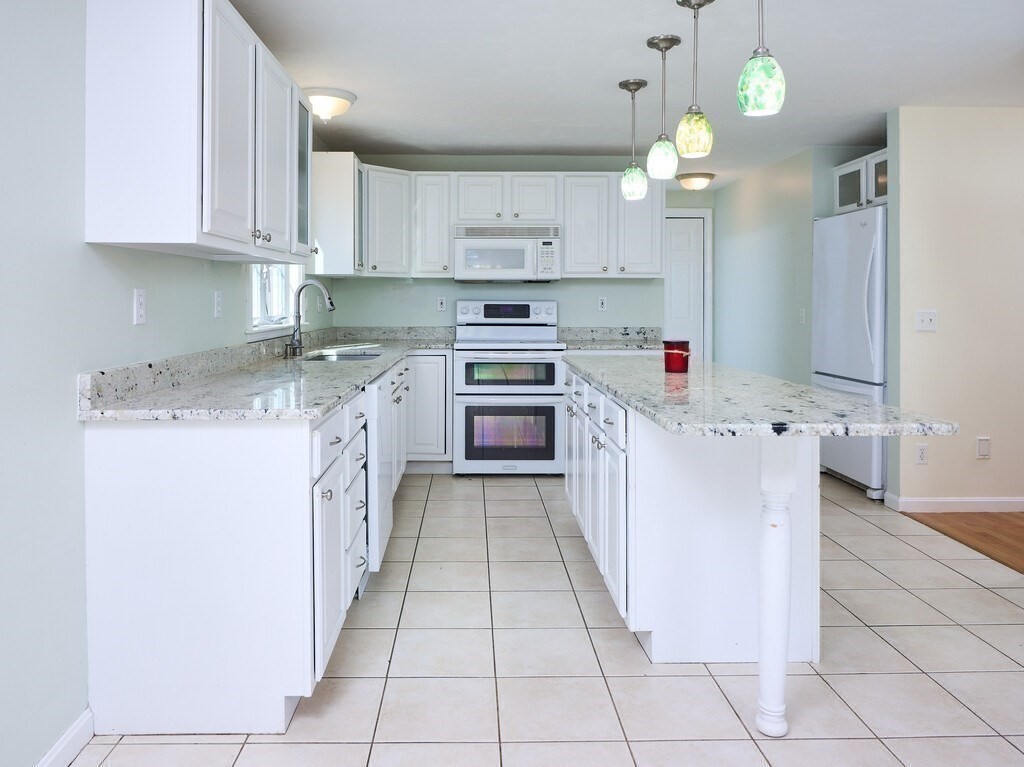 21 10 Rod Road Rutland, MA 01543 - Photo 8 of 42 a kitchen with stainless steel appliances granite countertop a stove a sink and a refrigerator