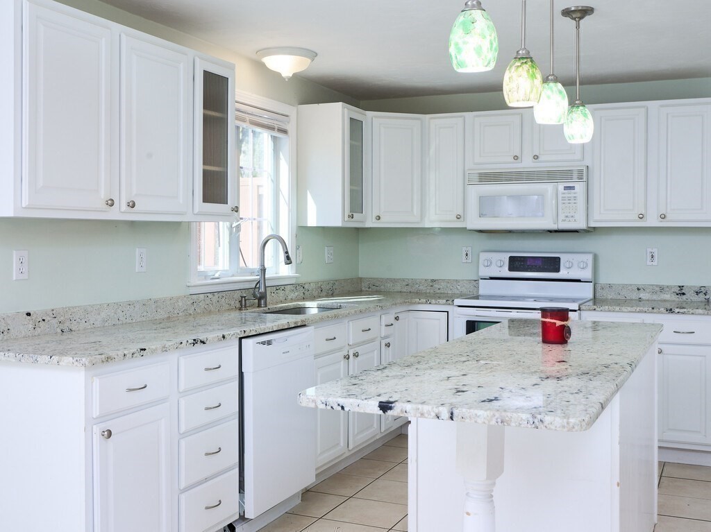 21 10 Rod Road Rutland, MA 01543 - Photo 9 of 42 a kitchen with stainless steel appliances granite countertop a sink and cabinets