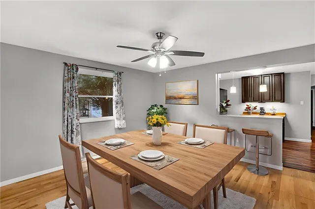a view of a dining room with furniture and wooden floor