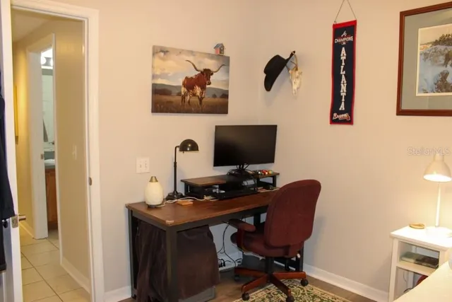 a view of a workspace with furniture and a mirror
