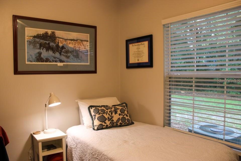 533 Northwest 50th Boulevard Gainesville, FL 32607 - Photo 16 of 19 a bedroom with a bed and a painting on the wall