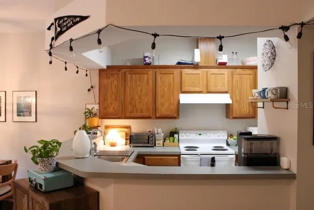 a kitchen with stainless steel appliances a sink a stove and a refrigerator