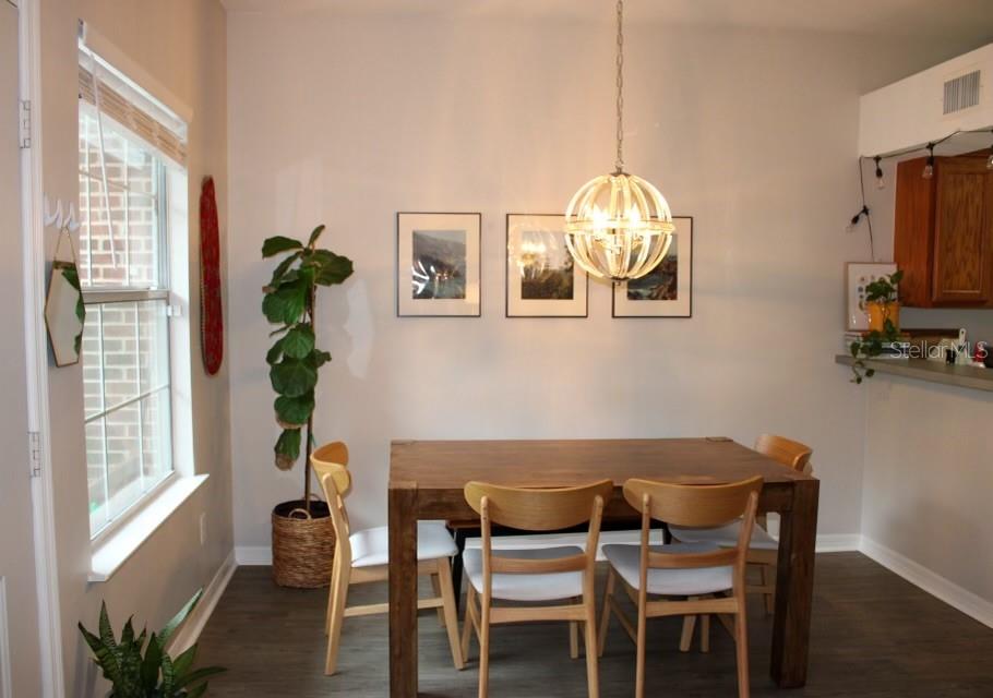 533 Northwest 50th Boulevard Gainesville, FL 32607 - Photo 9 of 19 a view of a dining room with furniture a chandelier and wooden floor