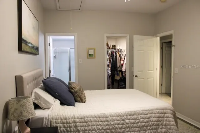 a bedroom with a bed and a mirror