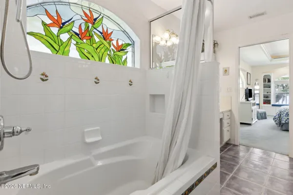 a bathroom with a sink a mirror and a shower