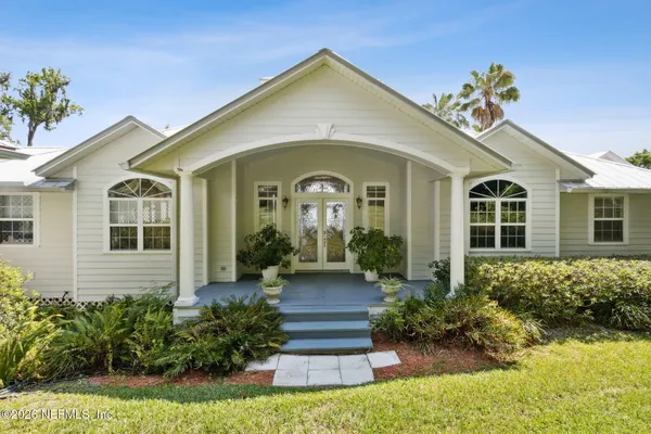 a front view of a house with garden
