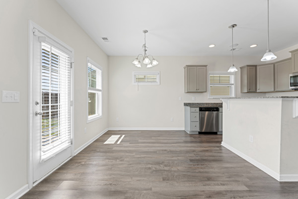 249 Samuel Street Pendleton, SC 29670 - Photo 13 of 33 This bright, open-concept area combines living and cooking, featuring ample light and modern finishes.