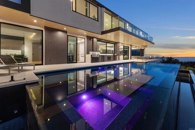 a view of a roof deck with couches and city view