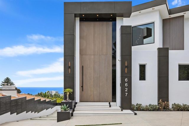 a view of a yard with wooden fence