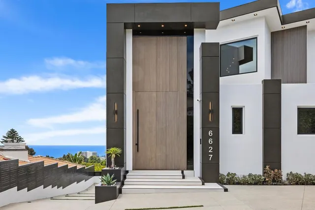a view of a yard with wooden fence