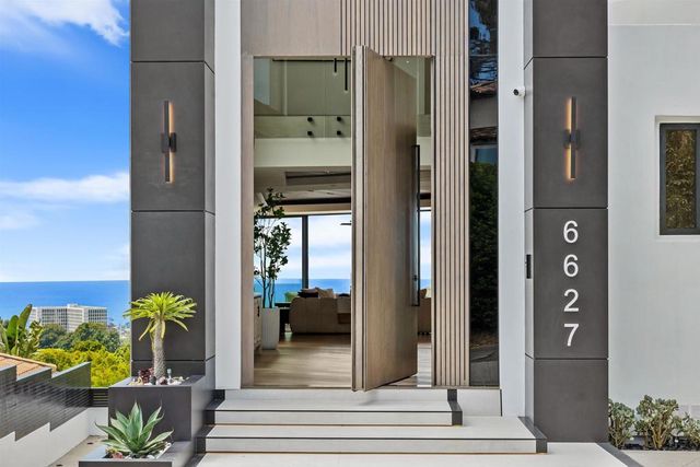 a kitchen with a sink cabinets and wooden floor