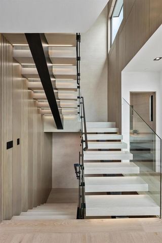 a living room with furniture a potted plant and a large window