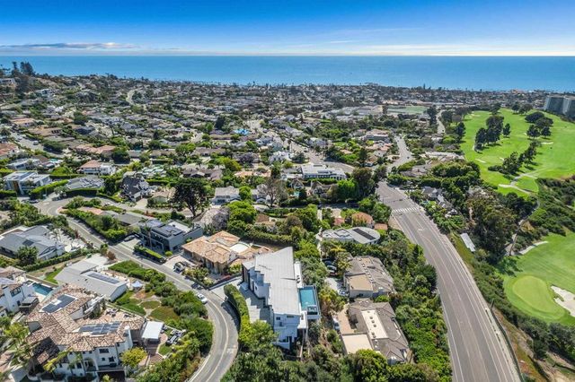 a bathroom with a glass shower door and a sink
