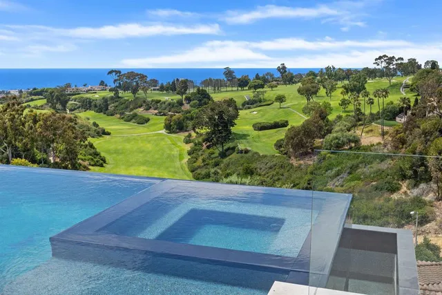 a living room with patio furniture and a large window