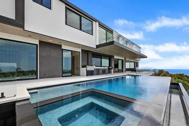 a spacious bedroom with a bed and a flat screen tv