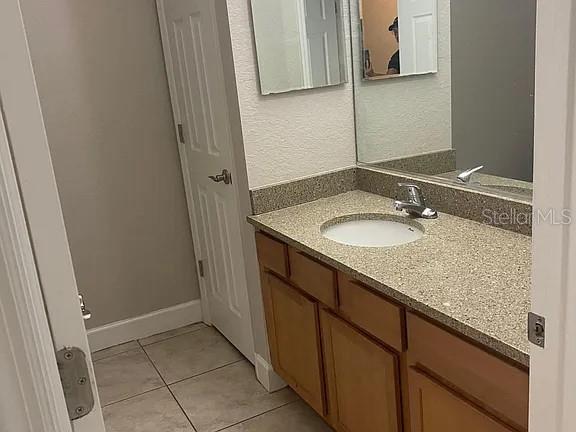 2508 Southwest 35th Place, Unit S111 Gainesville, FL 32608 - Photo 16 of 22 a bathroom with a granite countertop sink and a mirror
