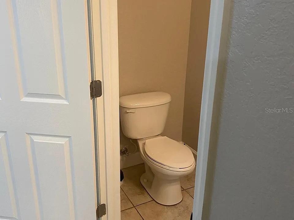 2508 Southwest 35th Place, Unit S111 Gainesville, FL 32608 - Photo 18 of 22 a white toilet sitting next to a shower curtain