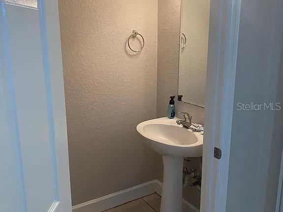 2508 Southwest 35th Place, Unit S111 Gainesville, FL 32608 - Photo 19 of 22 a bathroom with a sink a mirror and vanity