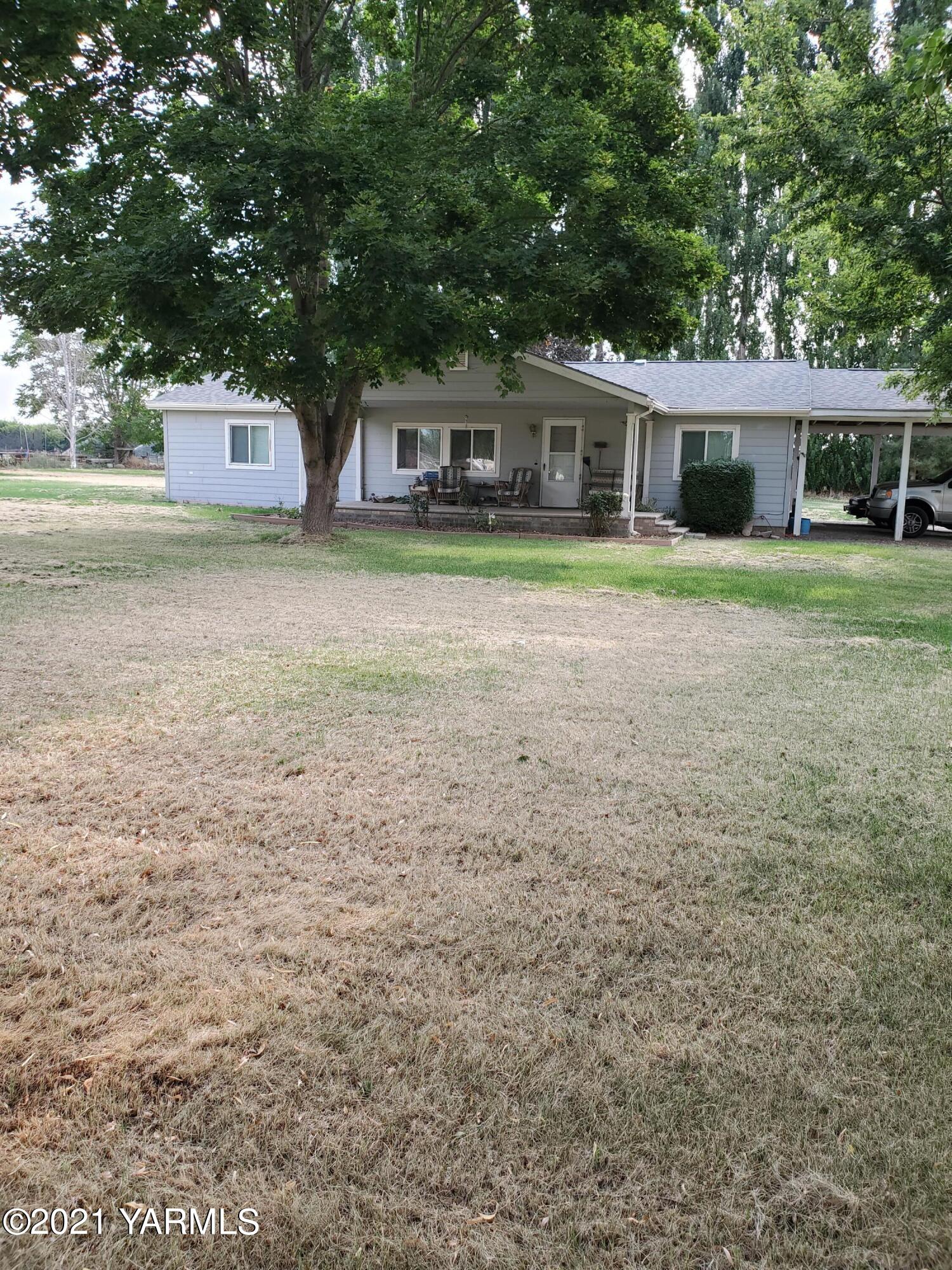 4205 Hicks Road Grandview, WA 98930 - Photo 1 of 12 a front view of a house with a yard and trees