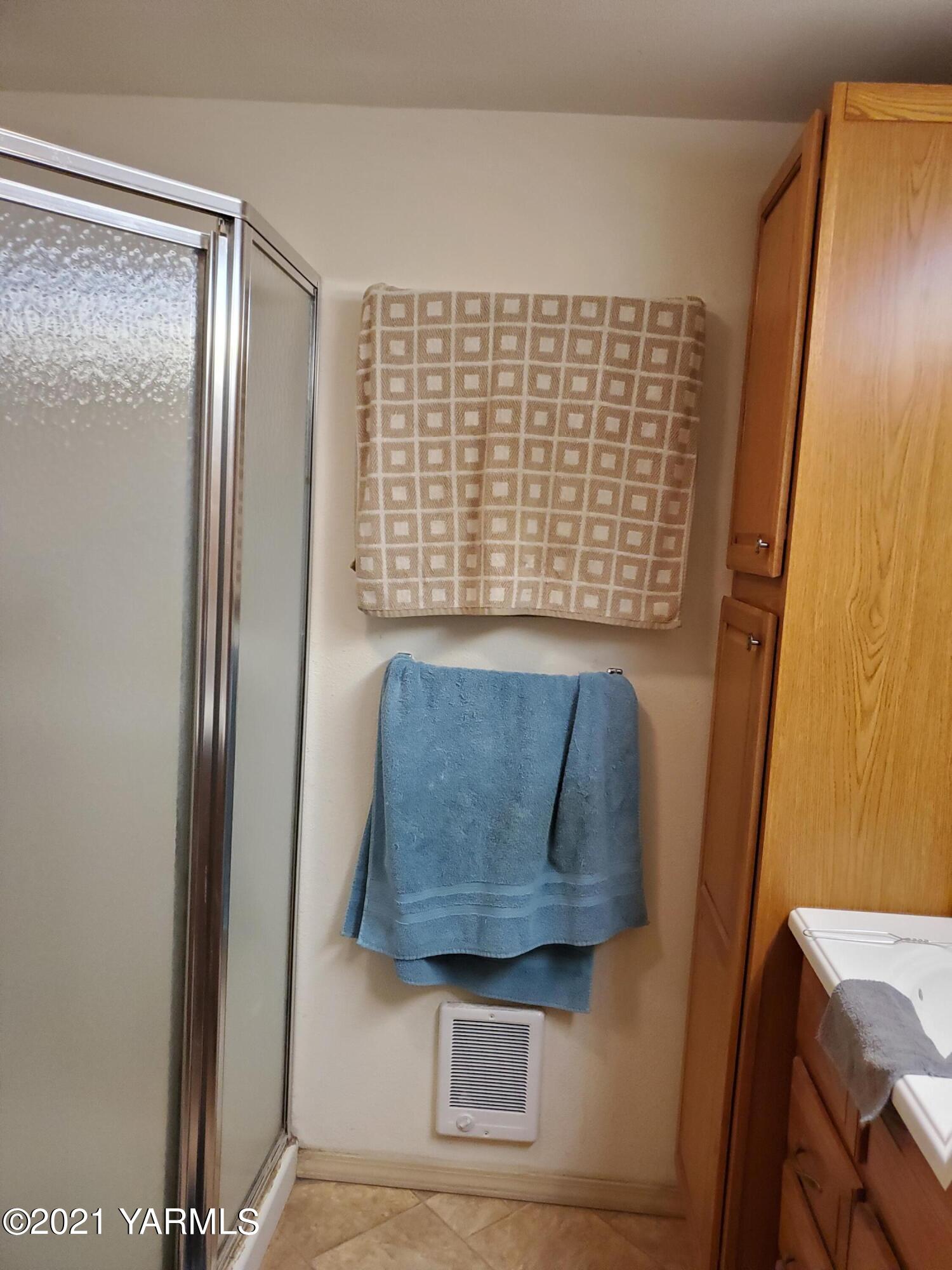 4205 Hicks Road Grandview, WA 98930 - Photo 7 of 12 a view of walk in closet with window and wooden floor