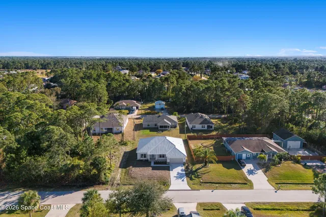 an aerial view of a house with a garden