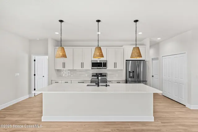 a view of living room kitchen with furniture and wooden floor