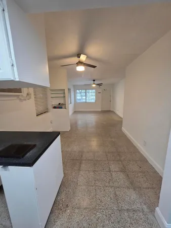 a kitchen with a sink cabinets and window