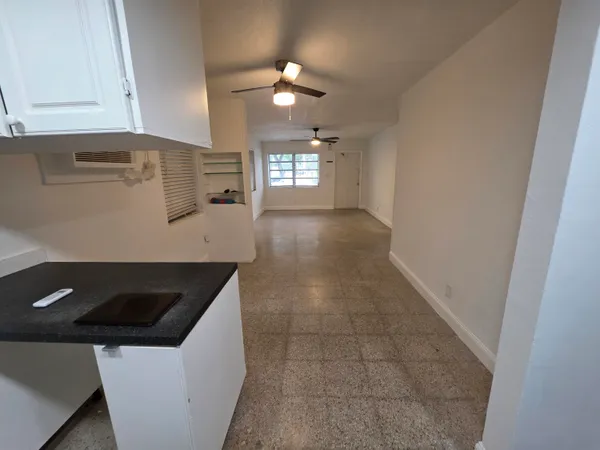 a kitchen with a sink a stove and cabinets