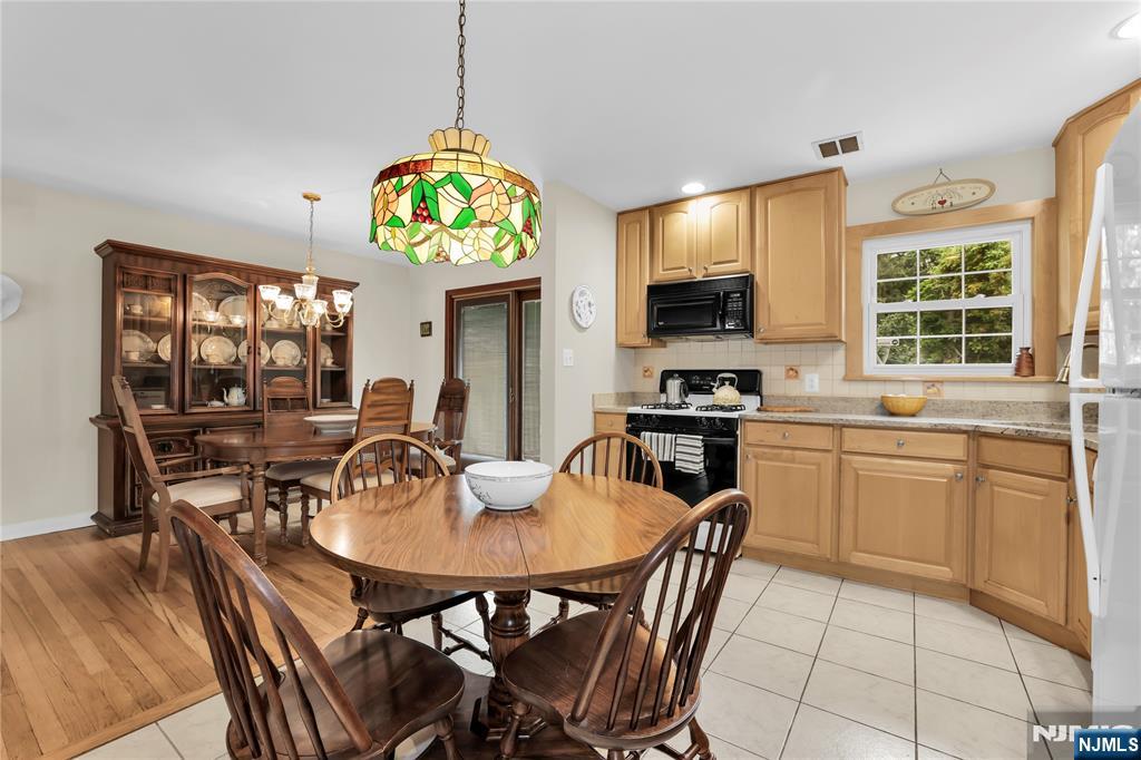 23 Ridge Court Cedar Grove, NJ 07009 - Photo 12 of 37 a kitchen with a dining table and chairs