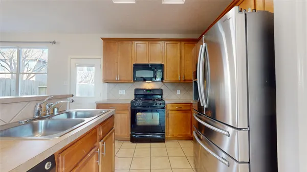 a kitchen with a stove a sink and a cabinets