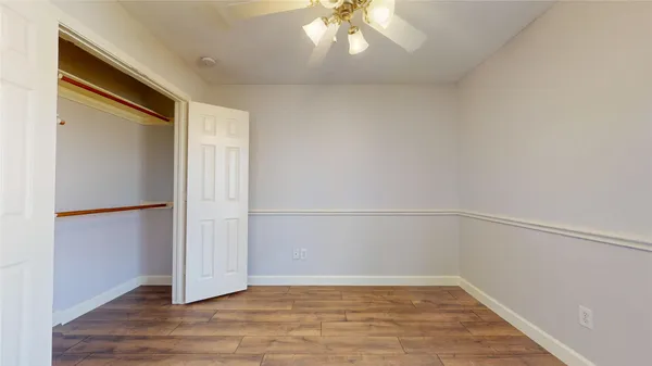 a view of hallway with wooden floor