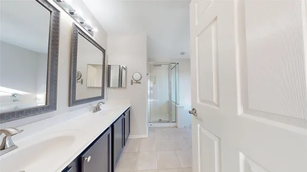 a bathroom with a sink vanity and mirror