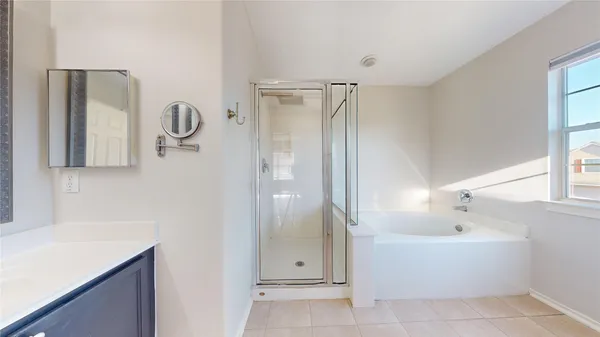a bathroom with a bathtub and next to a window