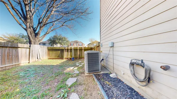 a view of a backyard with wooden fence