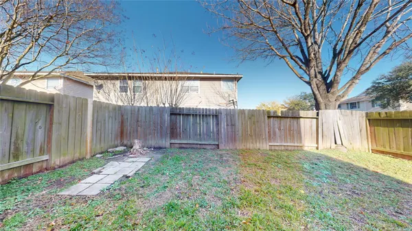 a view of a backyard with wooden fence
