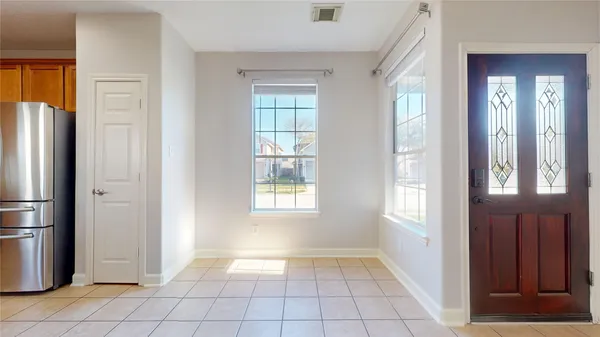 a view of an empty room with closet and a window