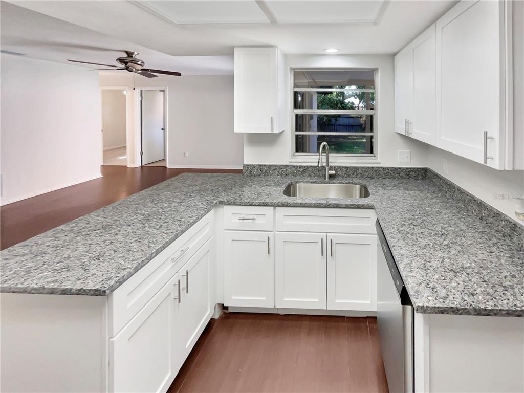 352 Sesame Avenue Apopka, FL 32703 - Photo 18 of 27 a kitchen with cabinets and window