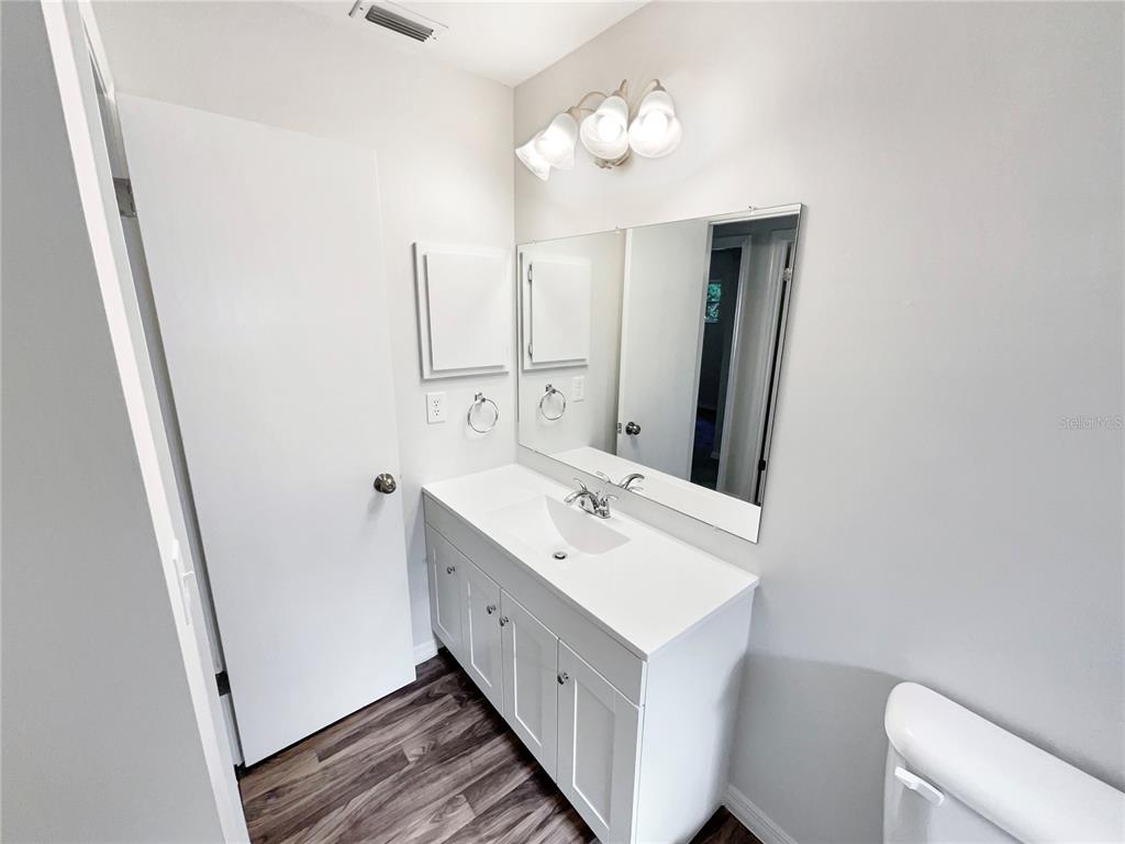 352 Sesame Avenue Apopka, FL 32703 - Photo 26 of 27 a bathroom with a double vanity sink and a mirror