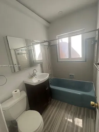 a bathroom with a sink a toilet and bathtub