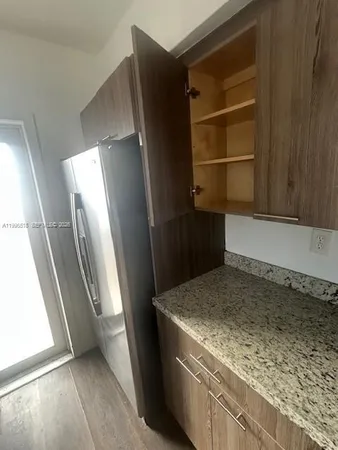 a view of a refrigerator in a kitchen