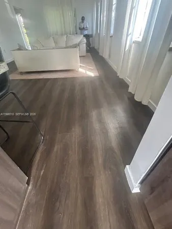 a view of a living room with wooden floor