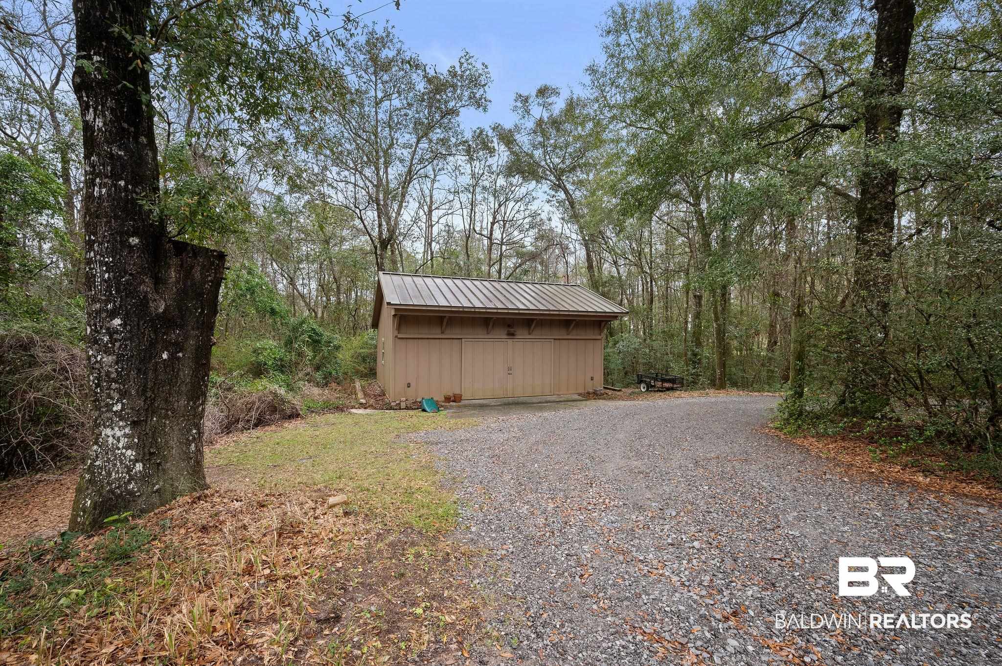 7850 Yorkhaven Road Mobile, AL 36695 - Photo 48 of 57 View of yard with an outbuilding and gravel driveway